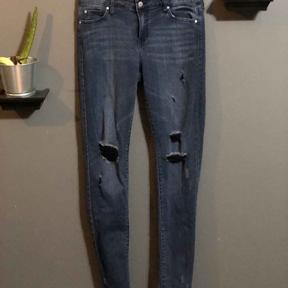 dark blue jeans with black rips